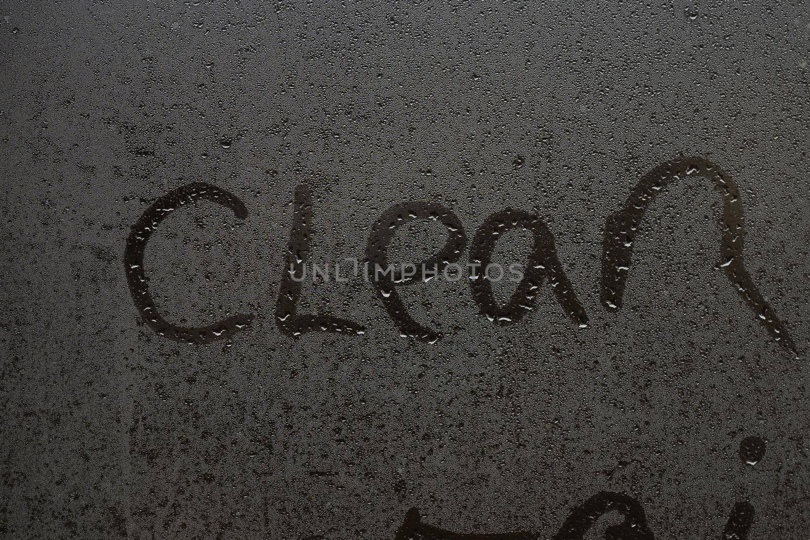 the word clean on a foggy window.