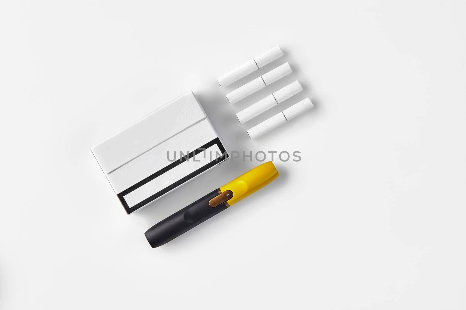 New generation black and yellow electronic cigarette, one pack and four heatsticks, isolated on white. Alternative technology. Heating tobacco system. Template place for your text. Close up, flat lay