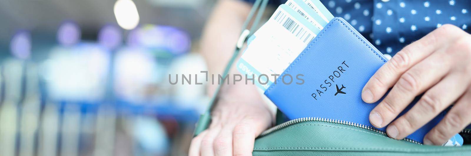 Man putting passport with plane tickets in laptop bag closeup. Flight by plane concept