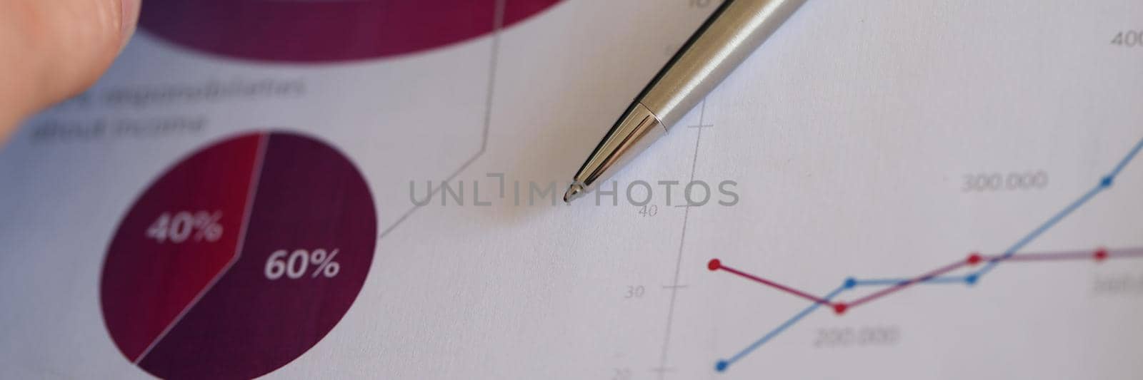 Man putting ballpoint pen and documents with charts in leather bag closeup by kuprevich