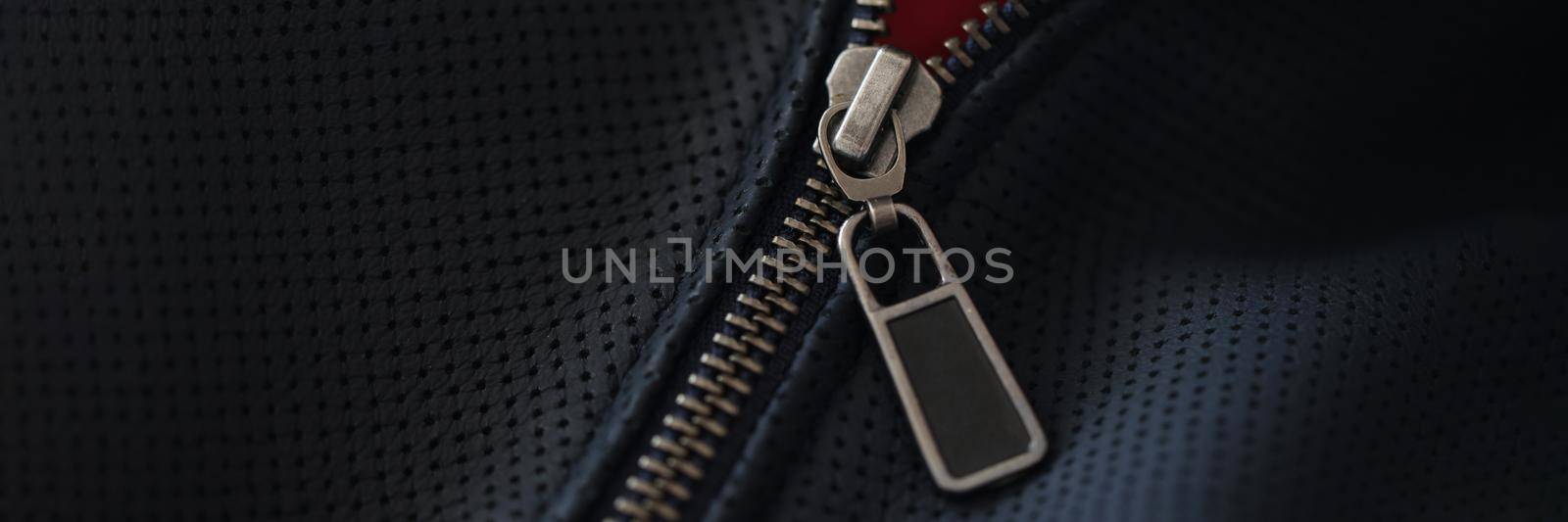 Closeup of steel zipper on leather jacket. Zipper replacement services concept