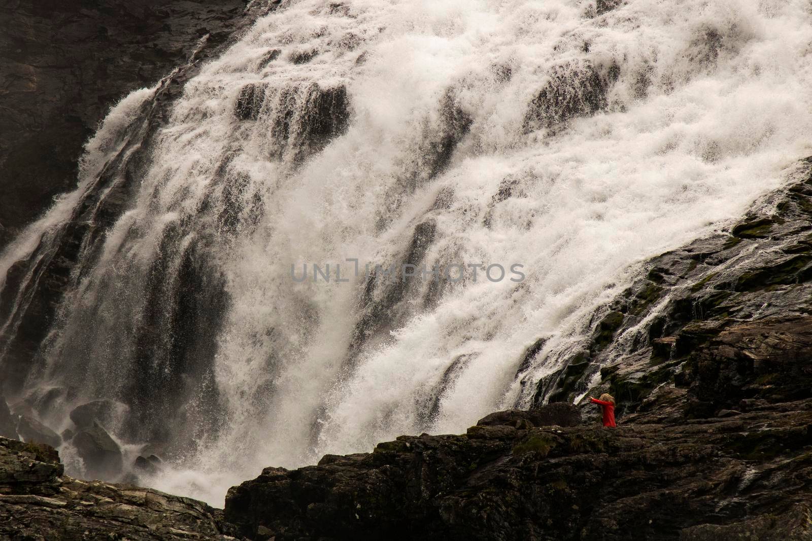 Woman in red dress in Kjosfossen by ValentimePix