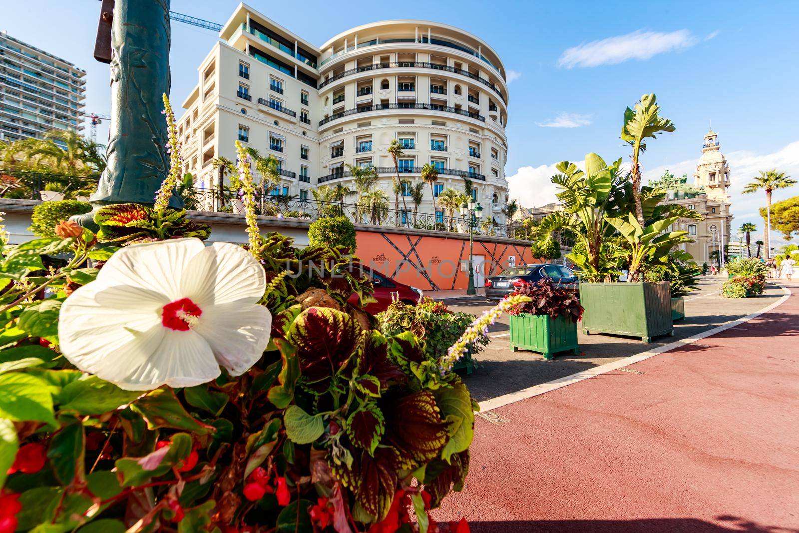 Monaco, Monte-Carlo, 21 August 2017: Branded shops near the hotel Paris and Casino Monte-Carlo at sunset, luxury life, expensive cars, wide angle. High quality photo