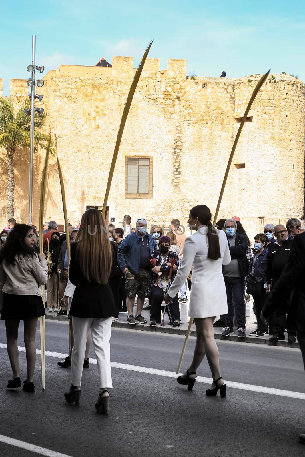 Elche, Alicante, Spain- April 10, 2022: People with white palms for the Palm Sunday of the Holy Week of Elche