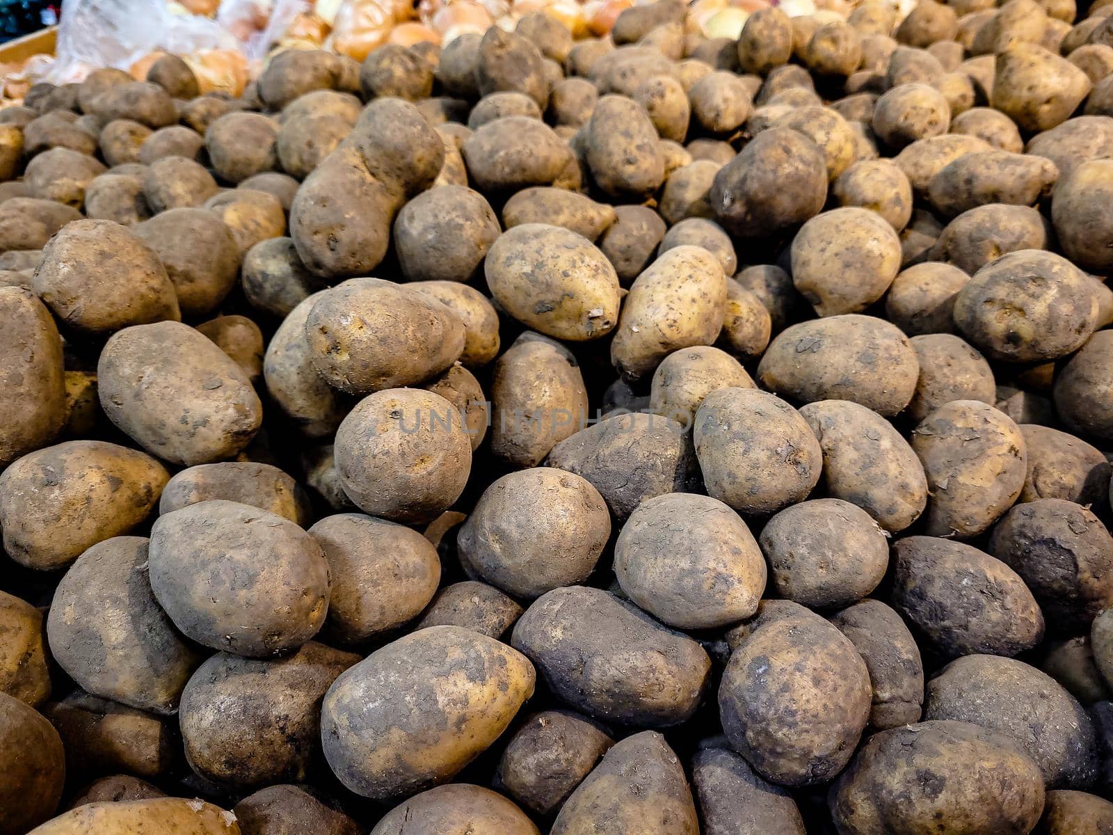 Natural farm potatoes are on the counter in the store by Milanchikov