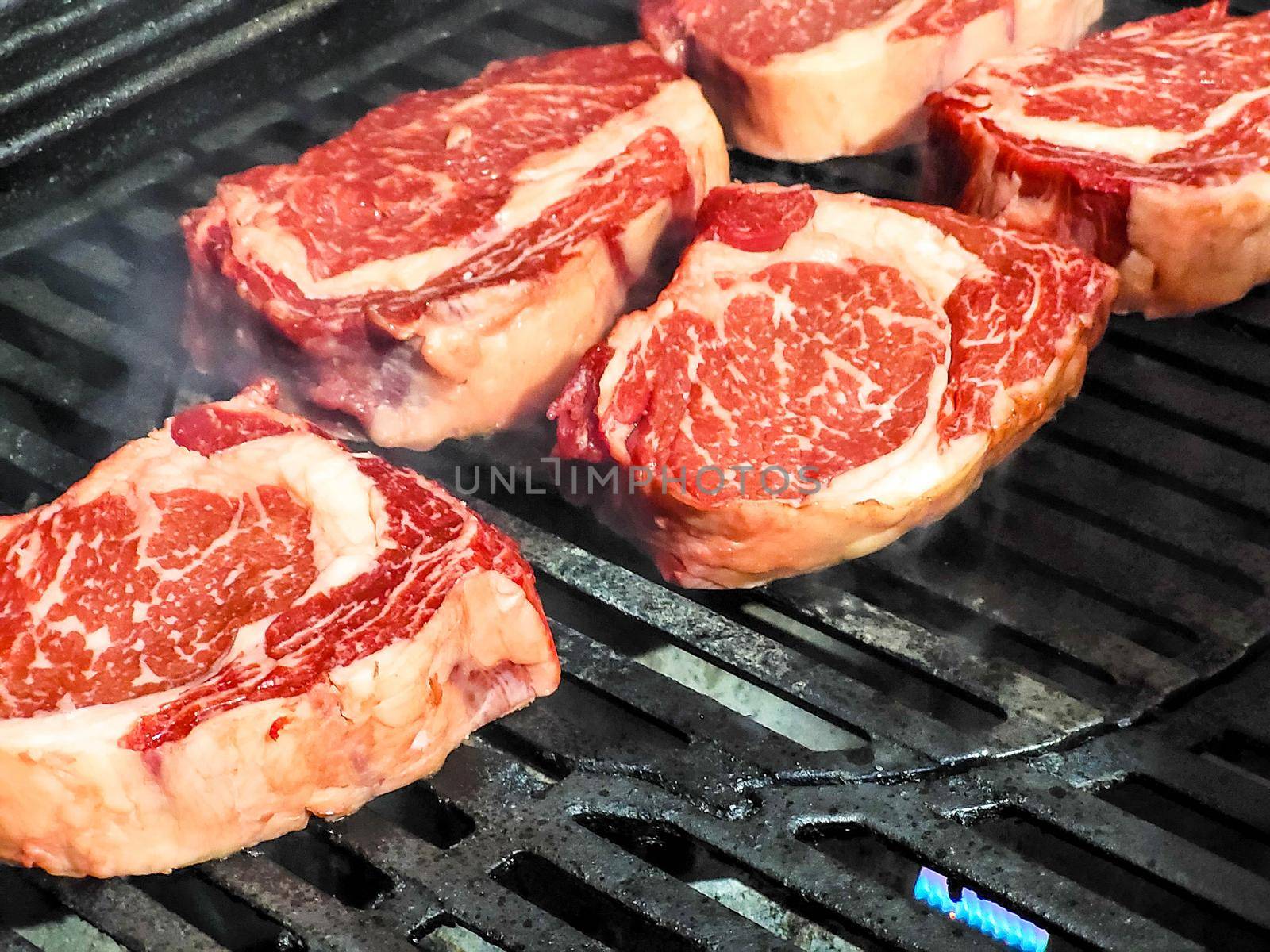 Marble beef rib eye steak is grilled by the chef