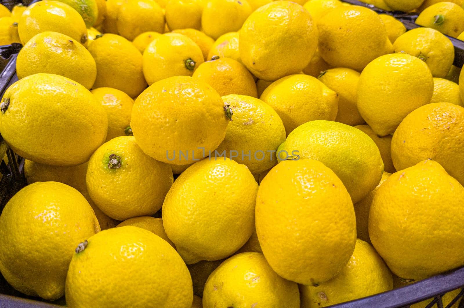 Fresh lemons are in a drawer in the store