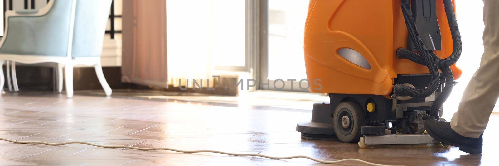 Cleaner washing floor in hotel using special machine closeup by kuprevich