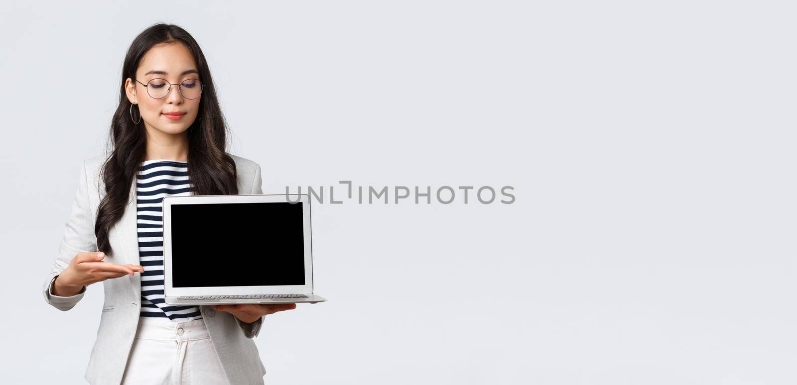 Business, finance and employment, female successful entrepreneurs concept. Professional businesswoman, real estate broker pointing finger at laptop screen, showing good deal apartment.