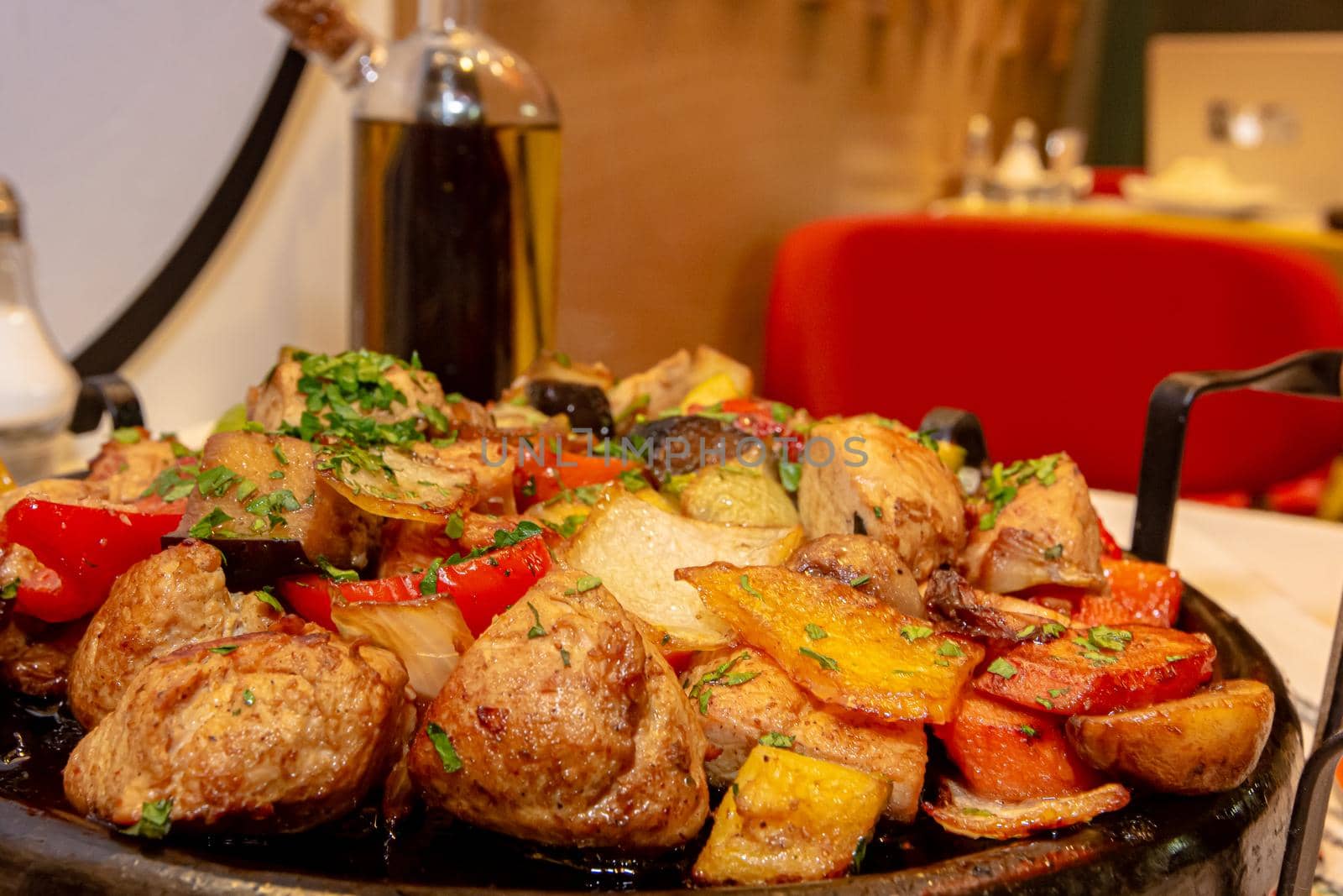Pan-fried potatoes, meat and vegetables for a large company.
