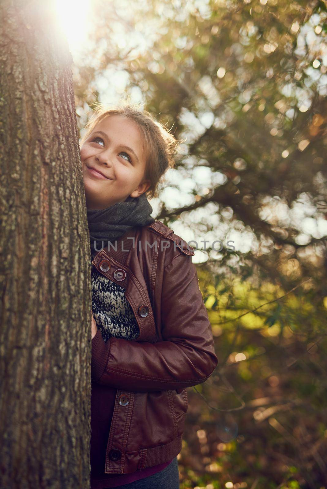 Shot of a little girl playing outdoors in a forest.