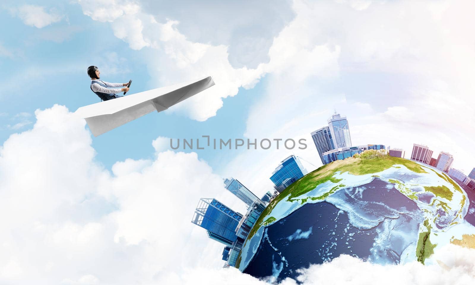 Funny aviator sitting in paper plane and holding steering wheel. Pilot driving paper plane in cloudy blue sky. Spherical view of modern city with high skyscrapers in business district.