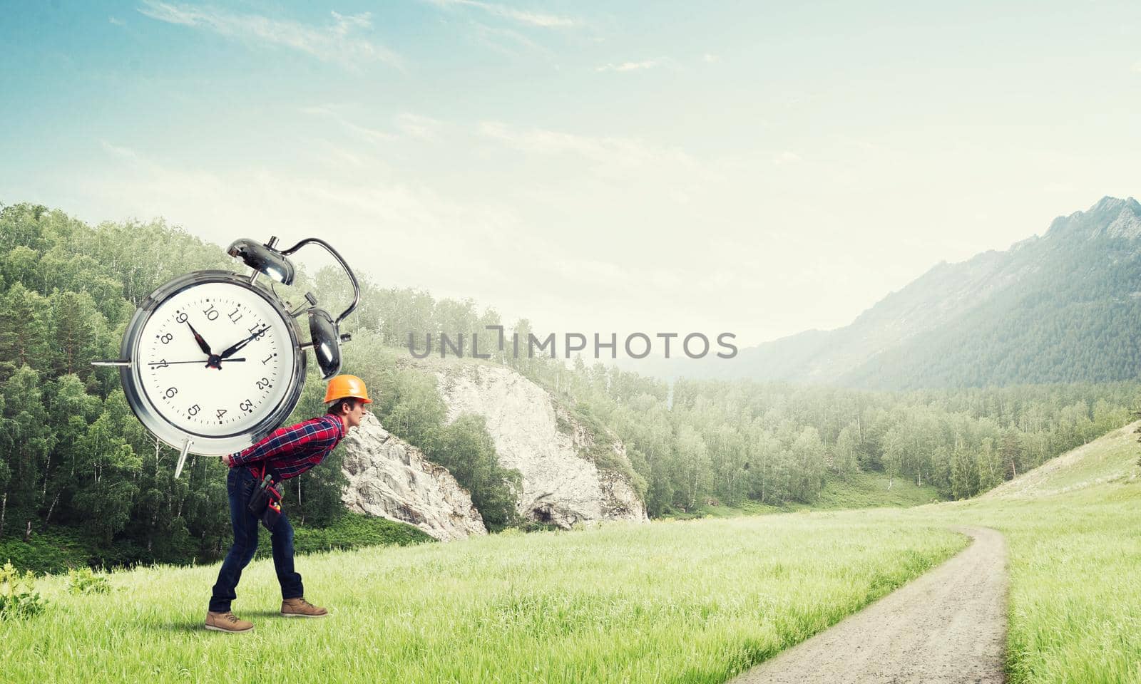 Builder man in helmet carrying alarm clock on back