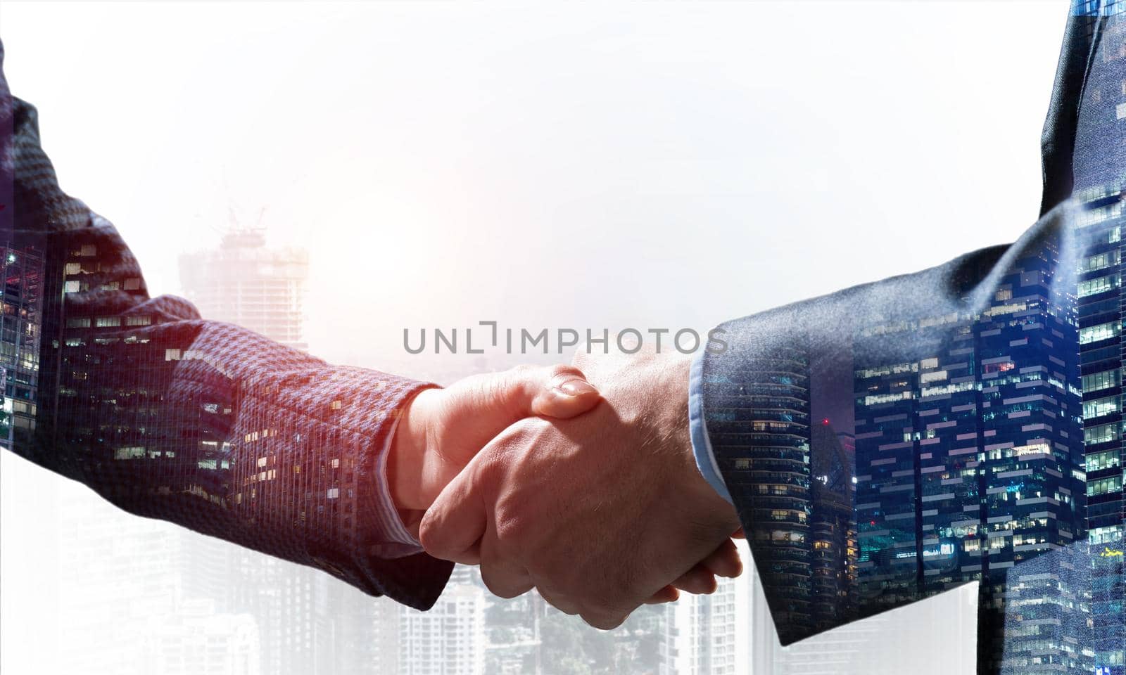 Close-up of the handshake of businessmen. Against the backdrop of the cityscape