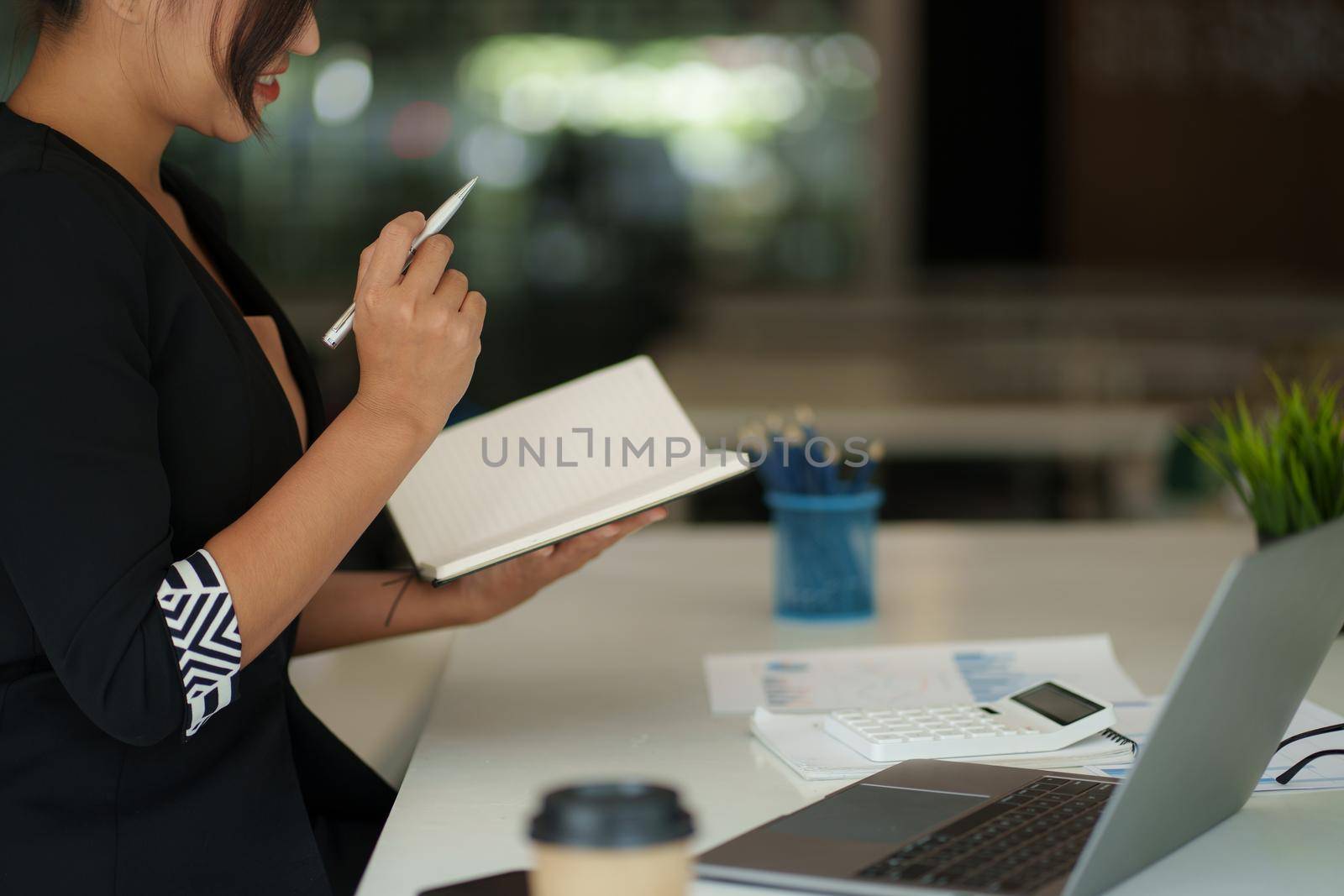 Beautiful Asian Business woman watching educational webinar on laptop computer. Finance concept