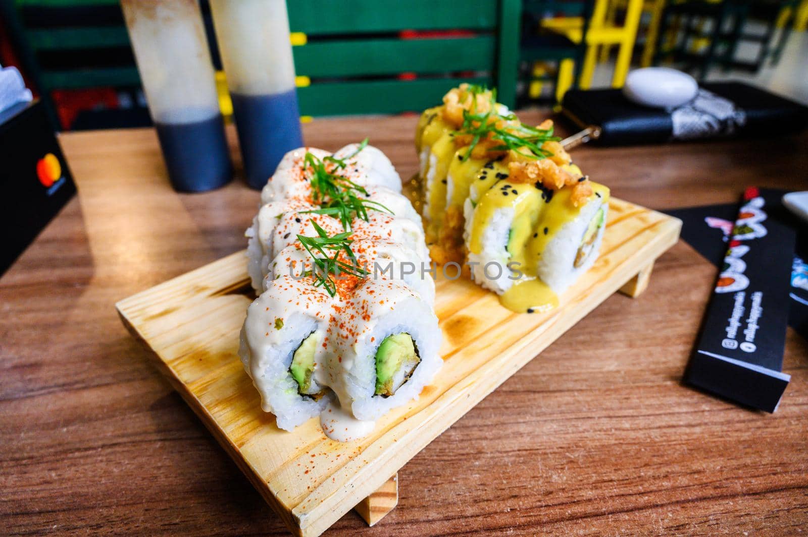 A table of makis, japanese food with a salsa