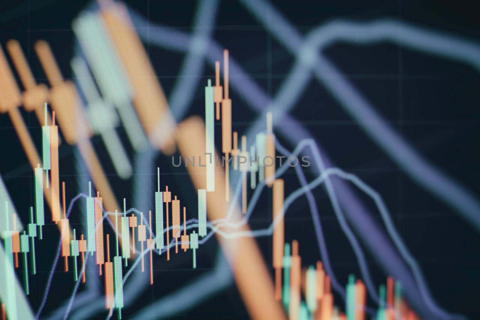 Concept of stock market and fintech. Blurry digital charts over dark blue background.