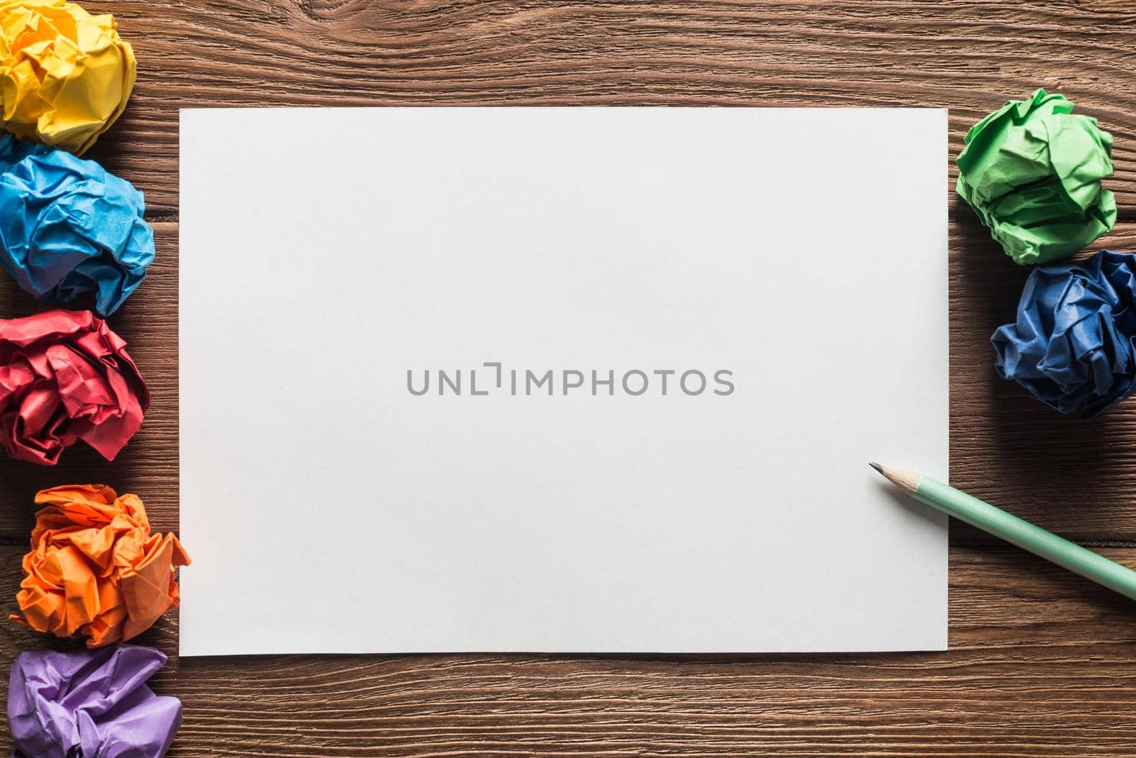 Close up of sheet of white paper and pencil on wooden table