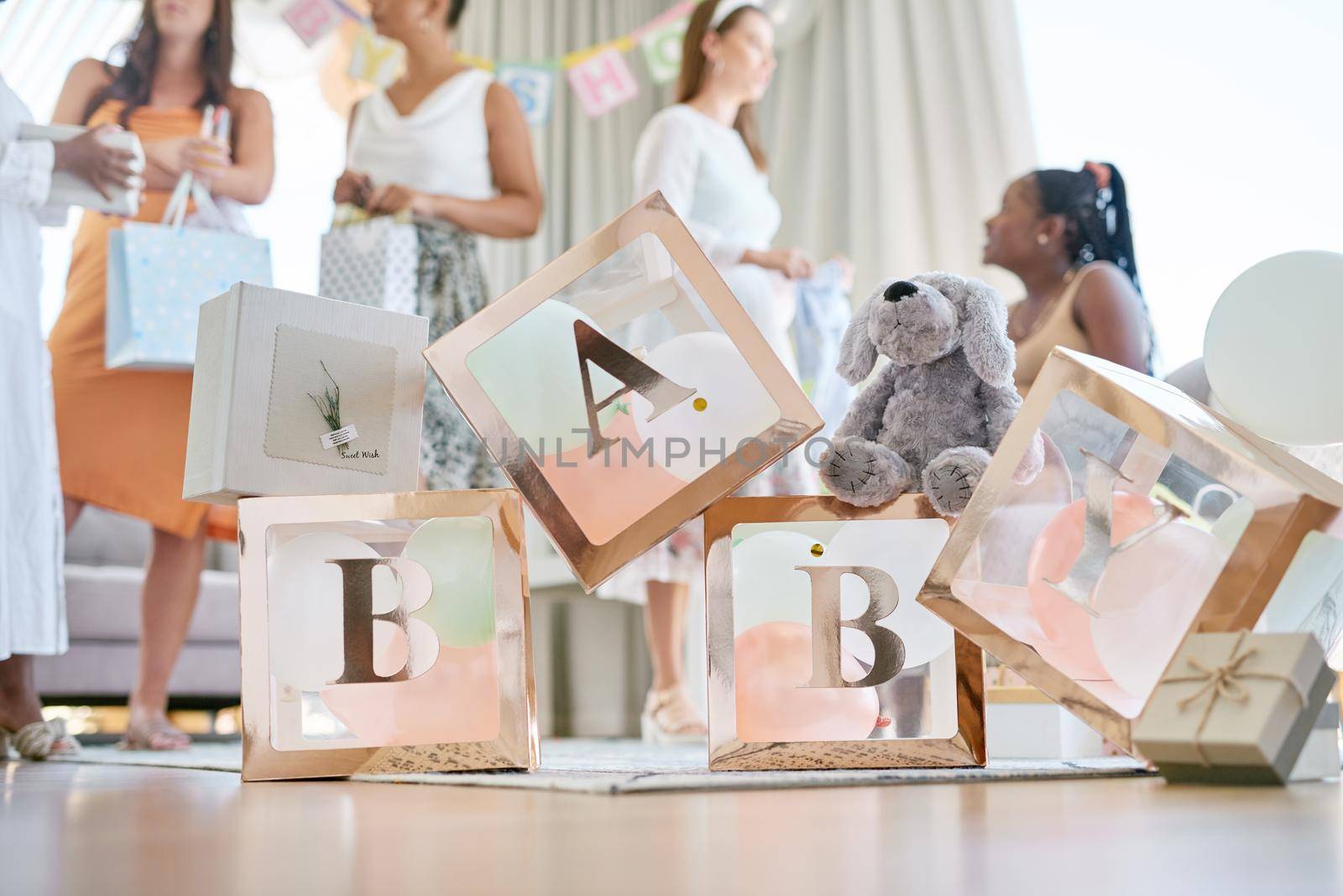Shot of a group of women holding a sign at a friends baby shower.