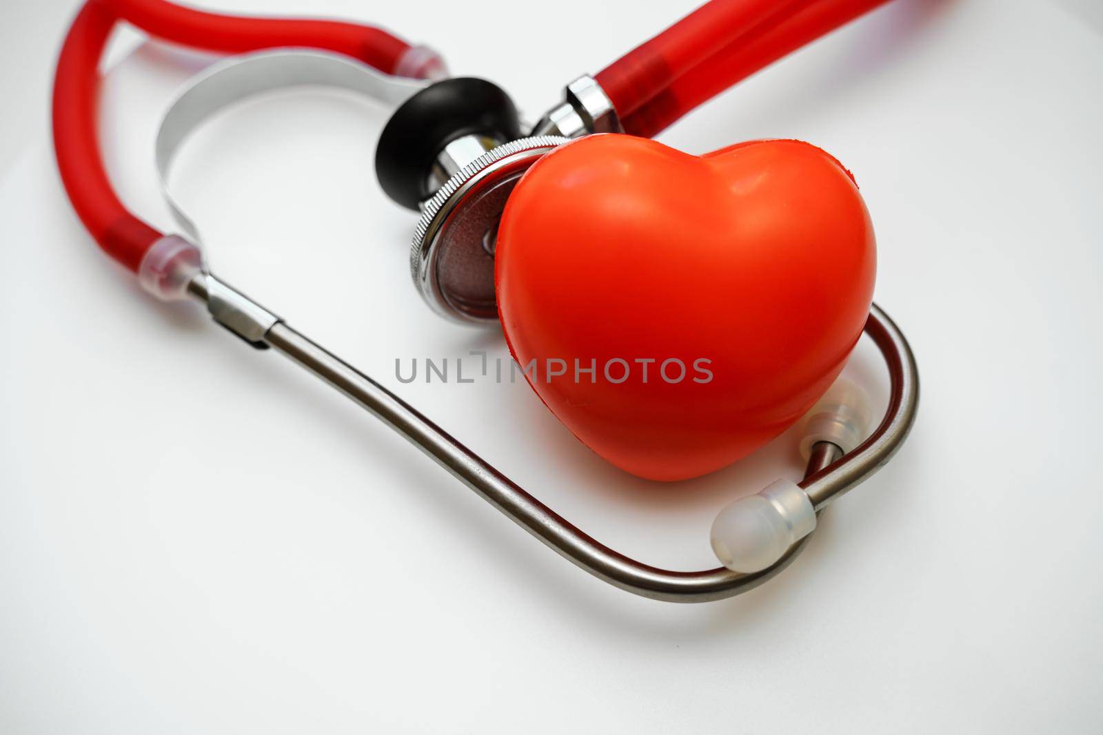 Stethoscope and red heart on white background, heart health, health insurance concept by Matiunina