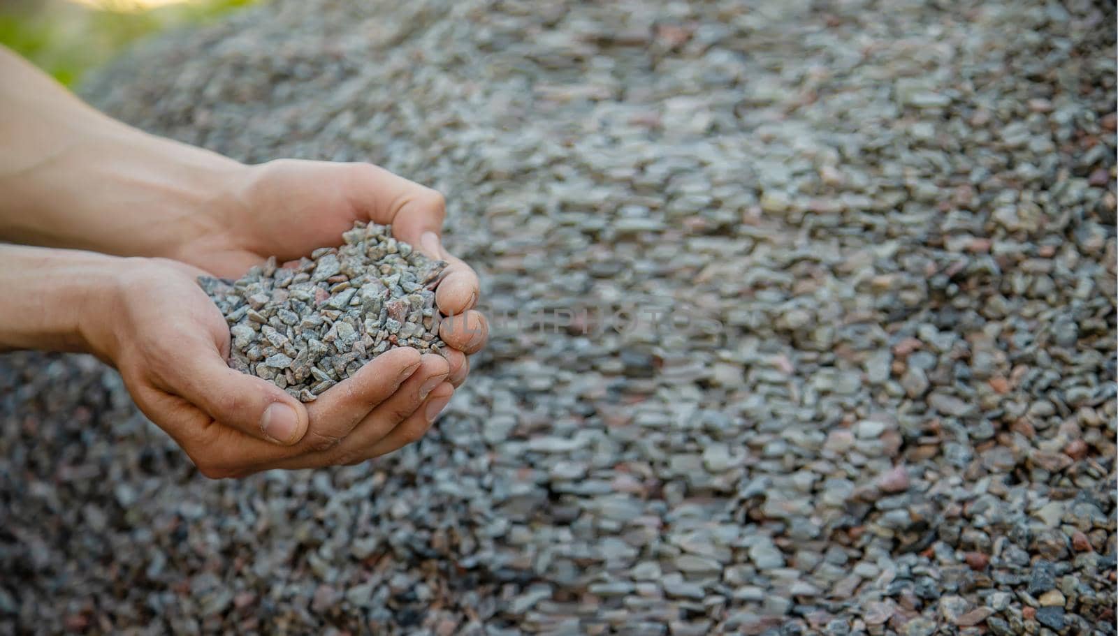 Man holding small rubble in his hands