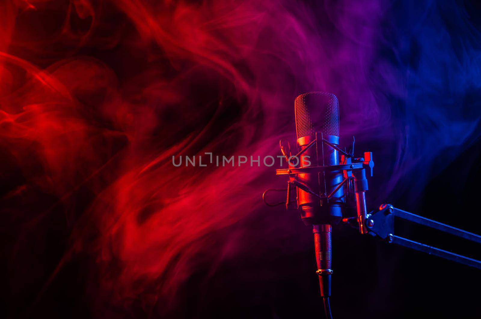 Professional microphone in pink smoke on a black background