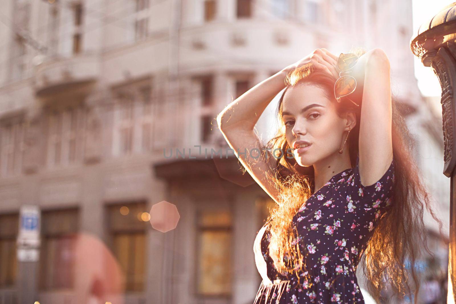 Portrait of stylish young woman. Brunette with curly hair in sundress posing on street. selective focus by Ashtray25