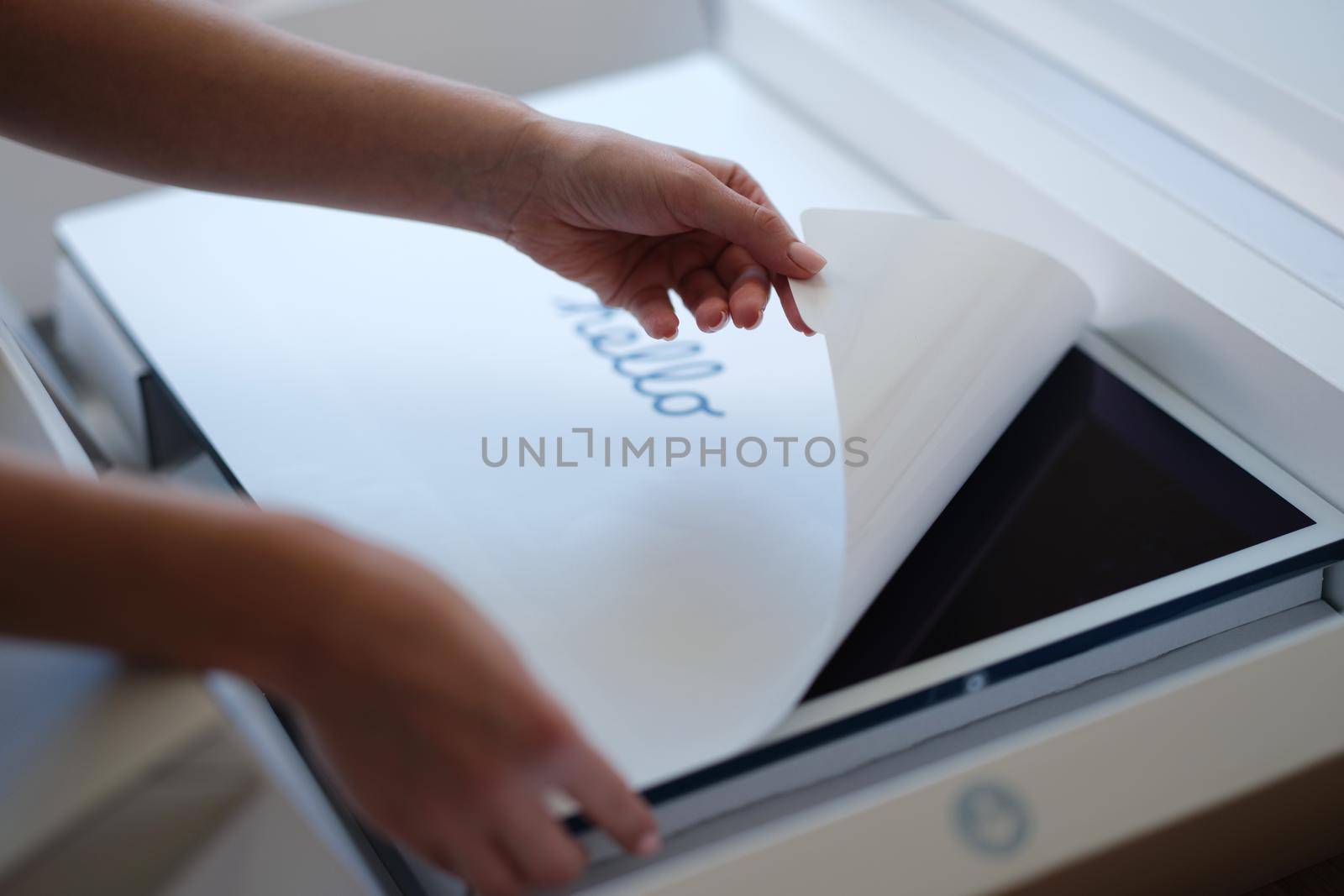 Tbilisi, Georgia - April 11, 2022: Woman removing protective film from New iMac monitor by kuprevich