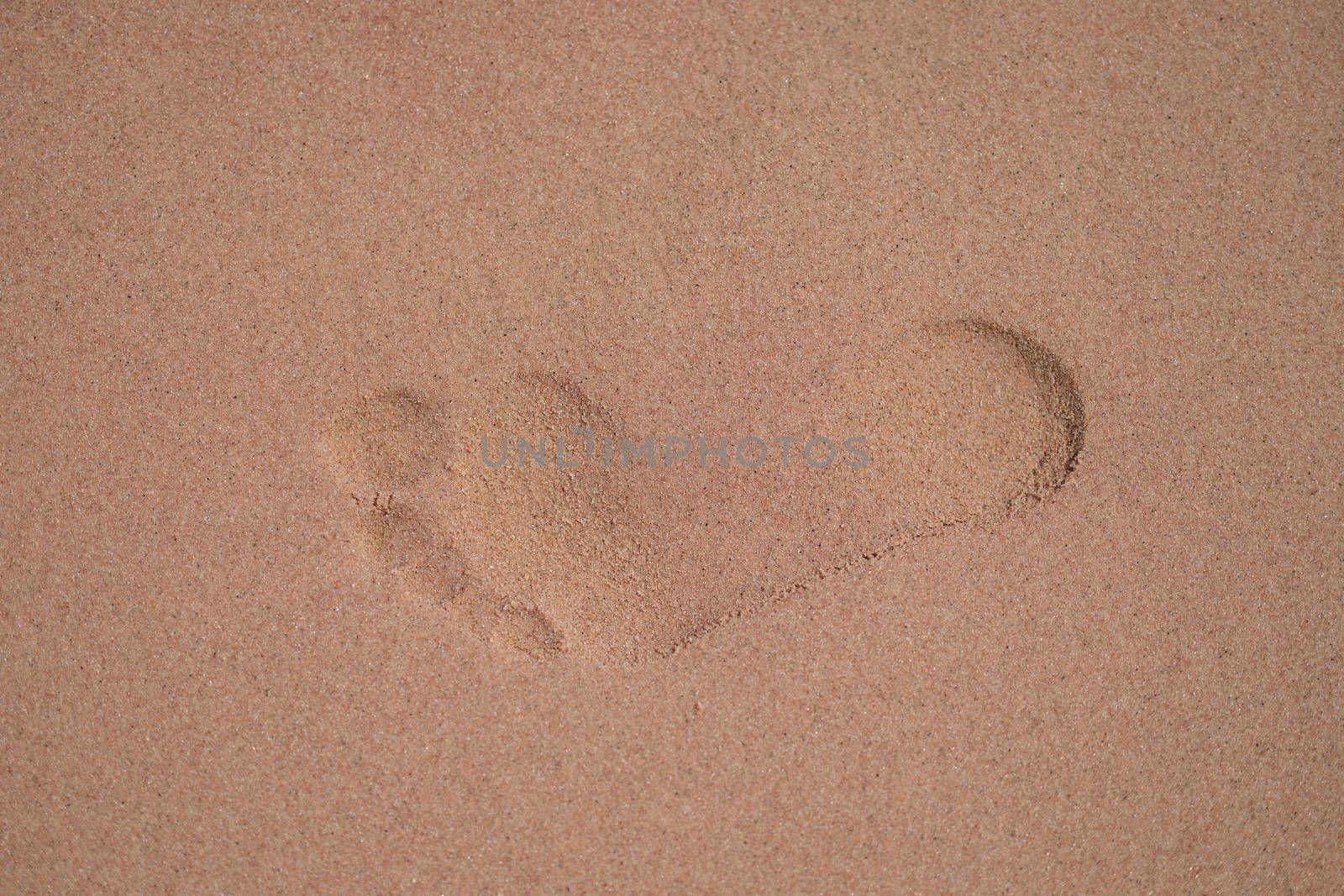 Footprints on wet sand sand on beach closeup by kuprevich