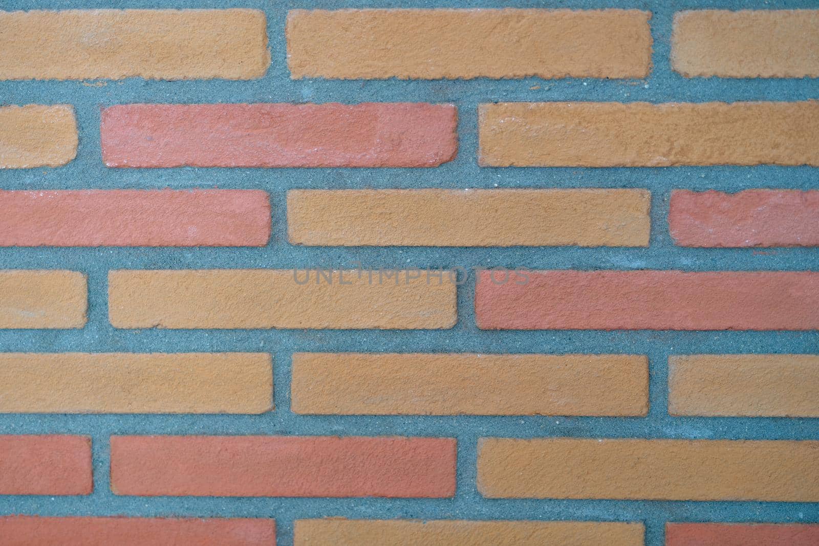 Stone wall made of rectangular bricks closeup. Building texture background