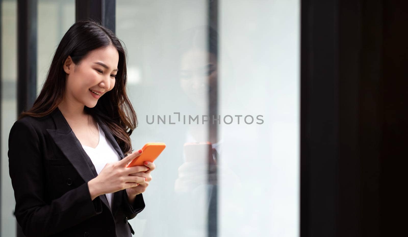 Beautiful cute asian young businesswoman in the office, woman using mobile phone.