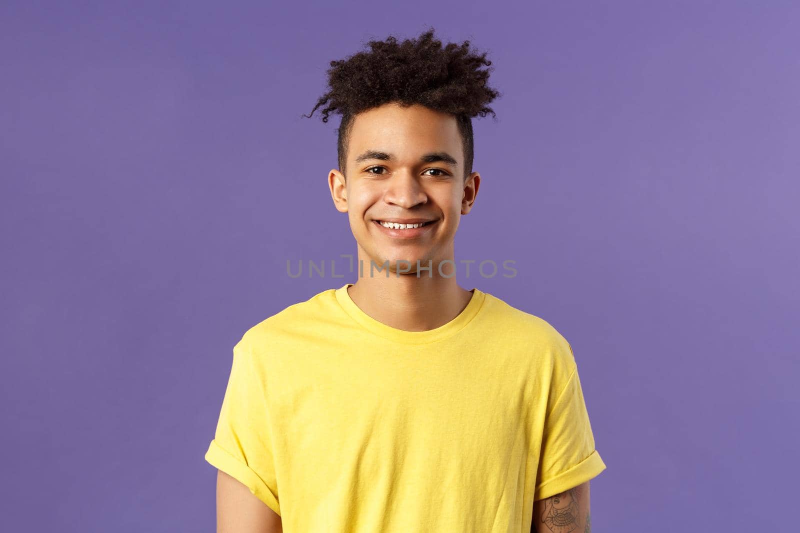 Close-up portrait of smiling, enthusiastic hispanic male student searching job, consider career opportunities, recruiting to company, smiling cheerful standing purple background.