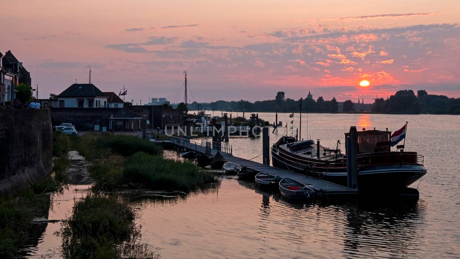 The harbor from Woudrichem at the river Merwede at sunset in the Netherlands