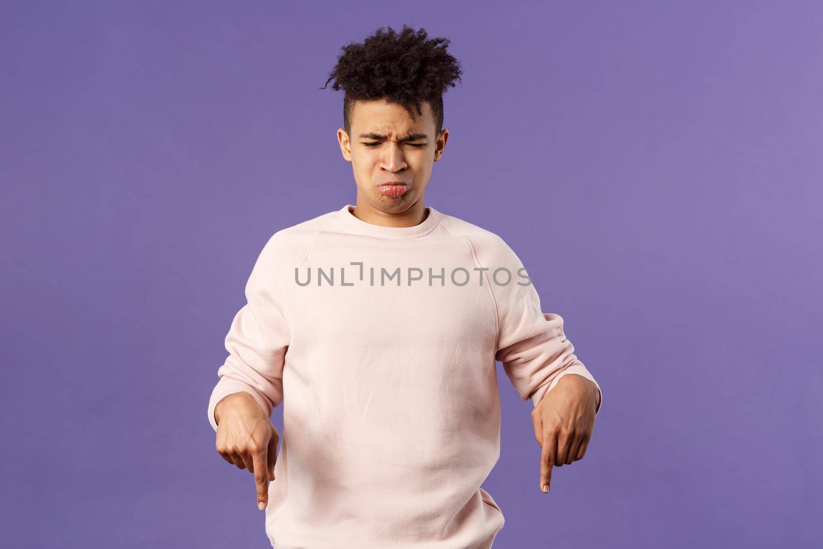 Portrait of gloomy and silly disappointed whining guy, sobbing and crying from envy or jealousy, regret missing chance, looking and pointing down with upset unhappy expression, purple background by Benzoix