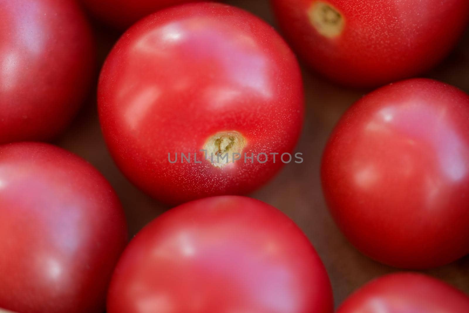 Ripe juicy healthy tomatoes in a box closeup by kuprevich