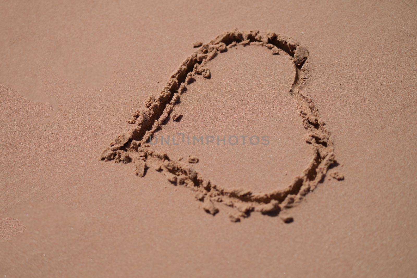 Drawn heart on wet sand on beach by kuprevich