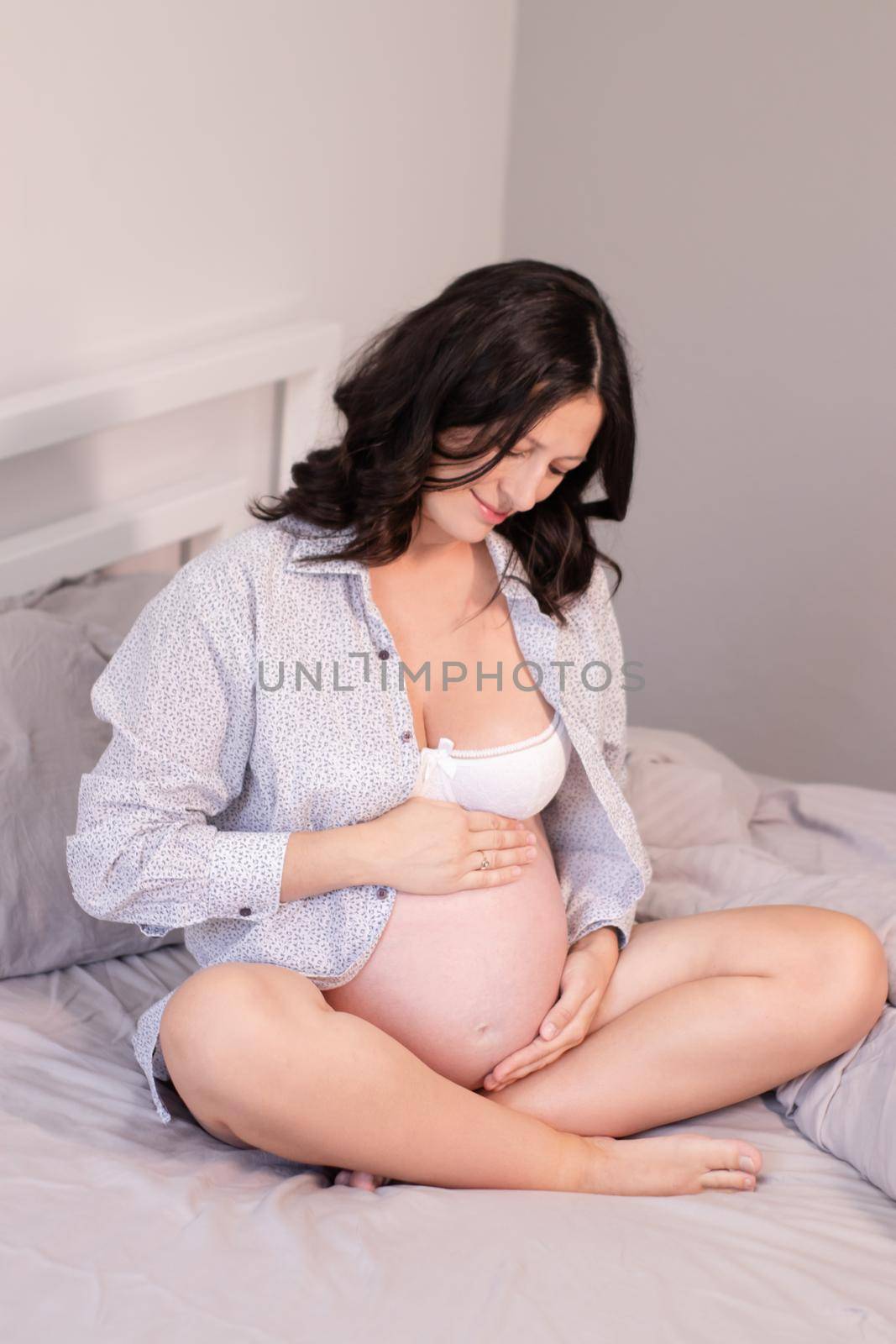 mother to be on bedchamber. pretty woman with big tummy. expecting parent mother. happy motherhood by oliavesna