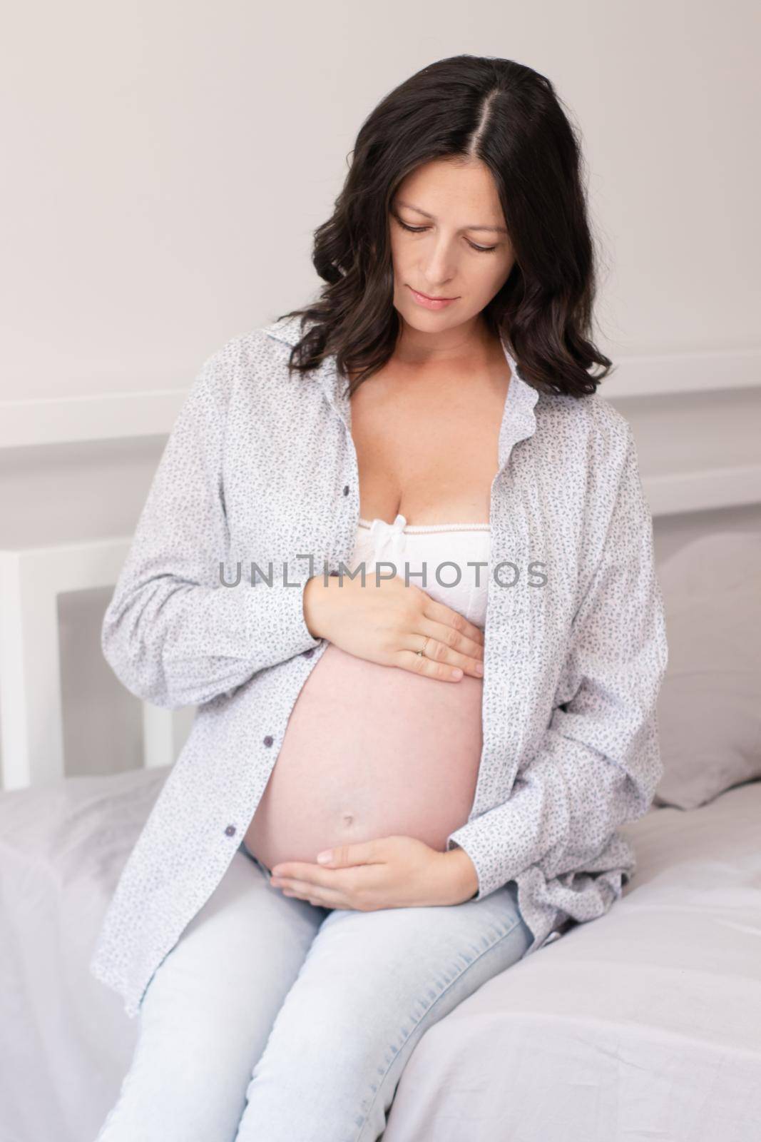 mother to be on bedchamber. pretty woman with big tummy. expecting parent mother. happy motherhood by oliavesna