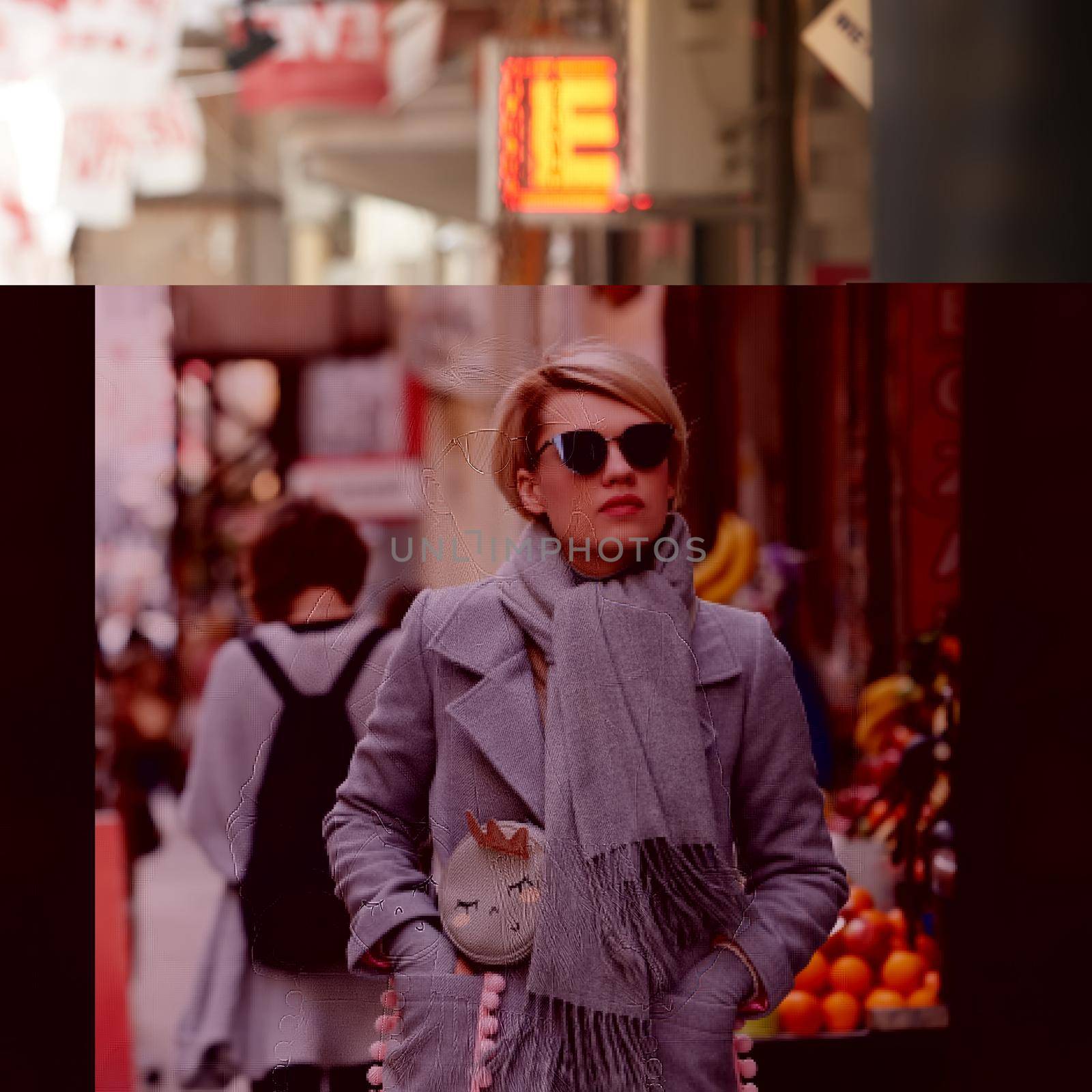 Young blond woman with sunglases on the street.