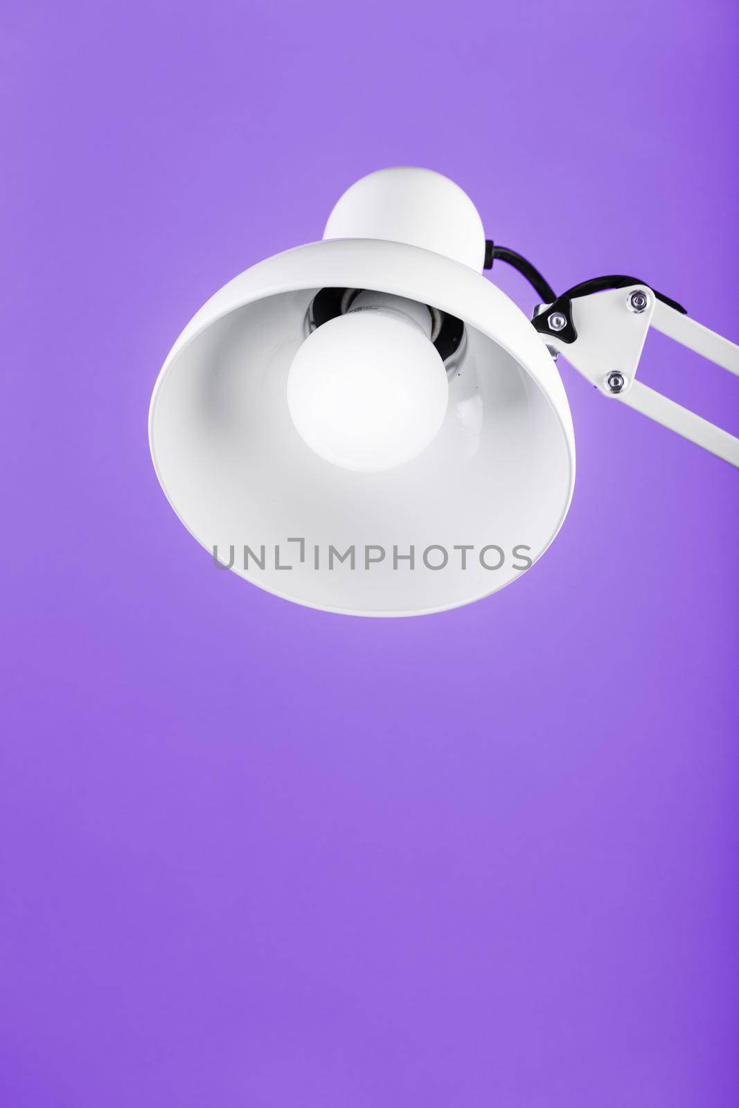 White table office lamp on pink background with space for text and idea concept