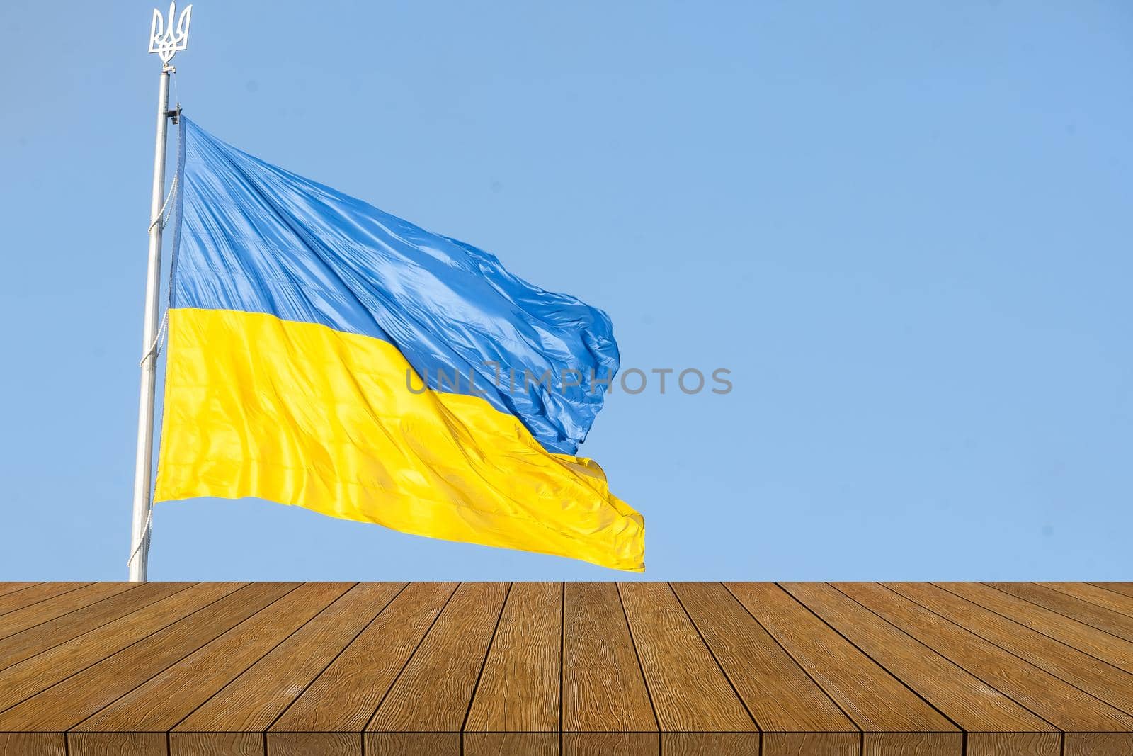 Ukraine flag on backgrounds textures tabletop, wooden board. by Andelov13