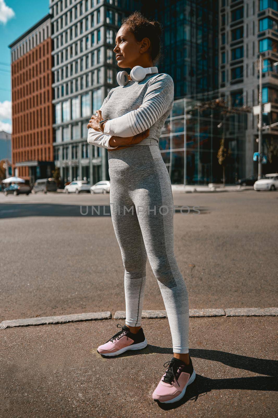 Sportswoman looking away while standing on an urban street. Sports concept