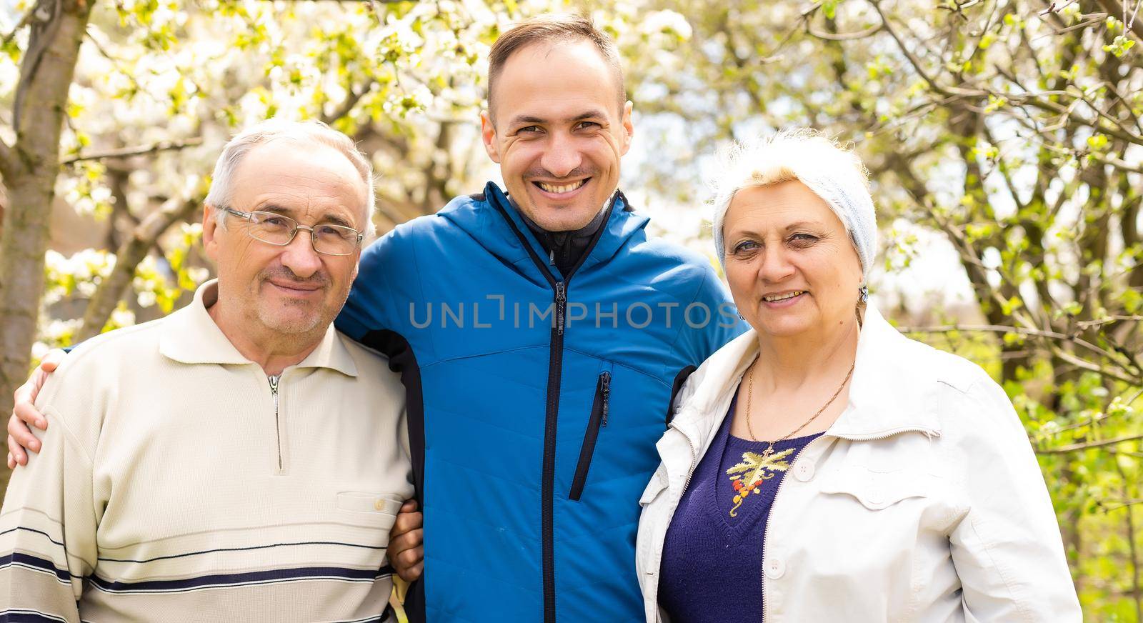 Portrait Of Family With Adult Son outdoors