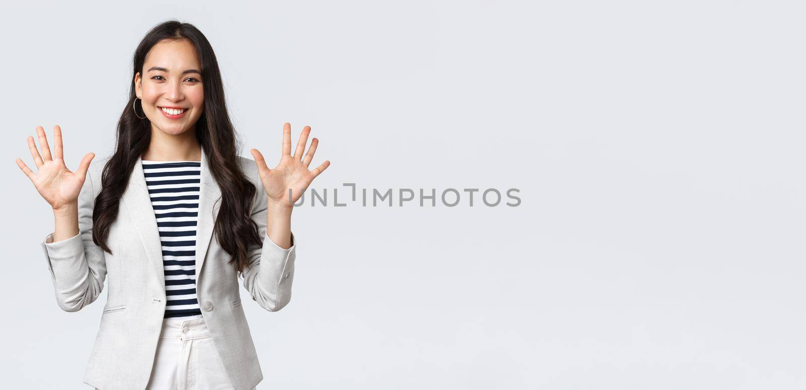 Business, finance and employment, female successful entrepreneurs concept. Smiling elegant asian woman in suit, businesswoman smiling and showing ten fingers, propose good deal.