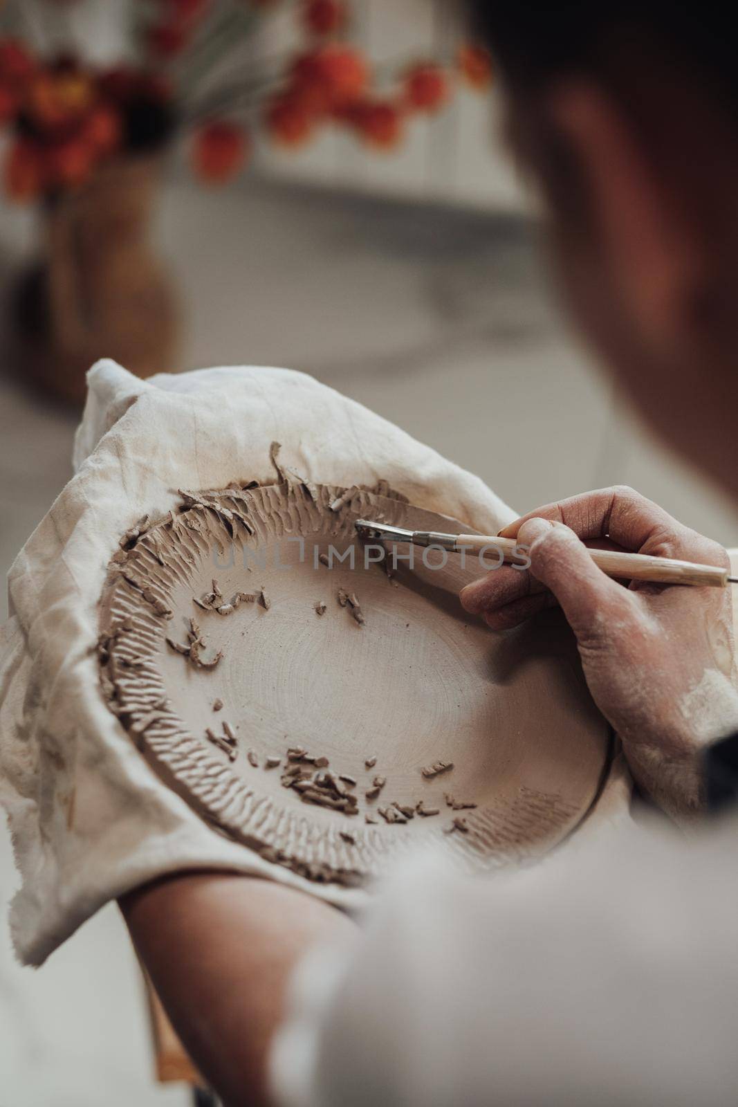 Close Up of Female Pottery Artist at Work, Woman Creating Patterns on a Clay Plate, Art Work in Process by Romvy