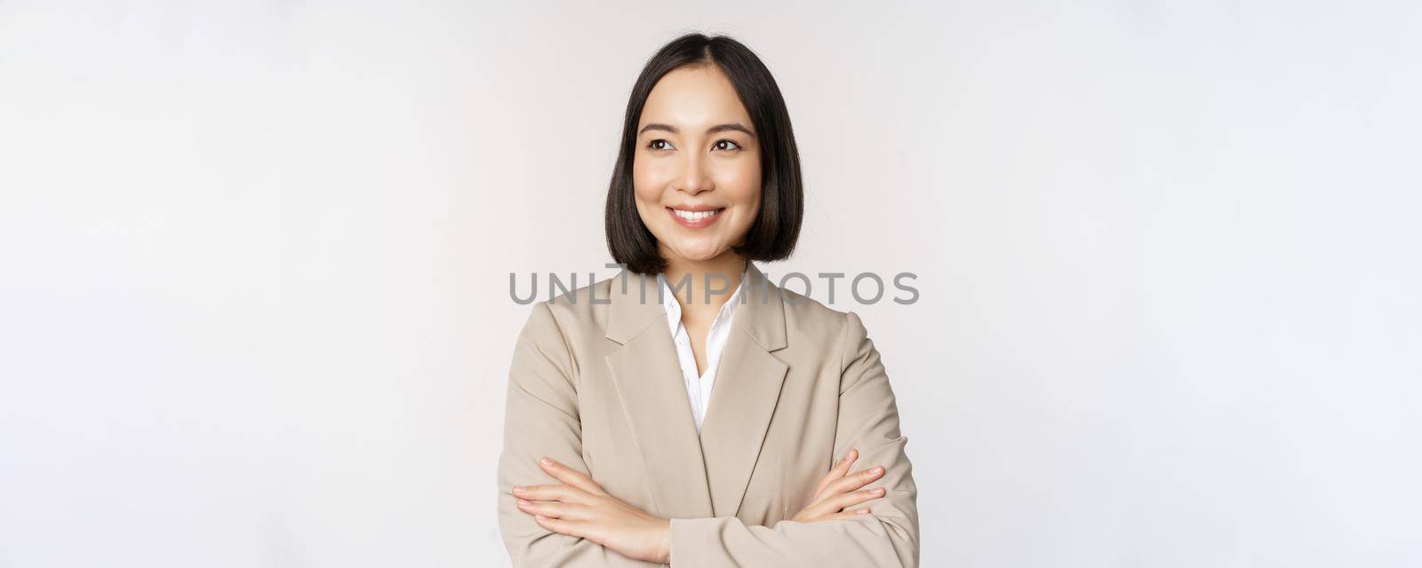 Confident female entrepreneur, asian business woman standing in power pose, professional business person, cross arms on chest, standing over white background by Benzoix