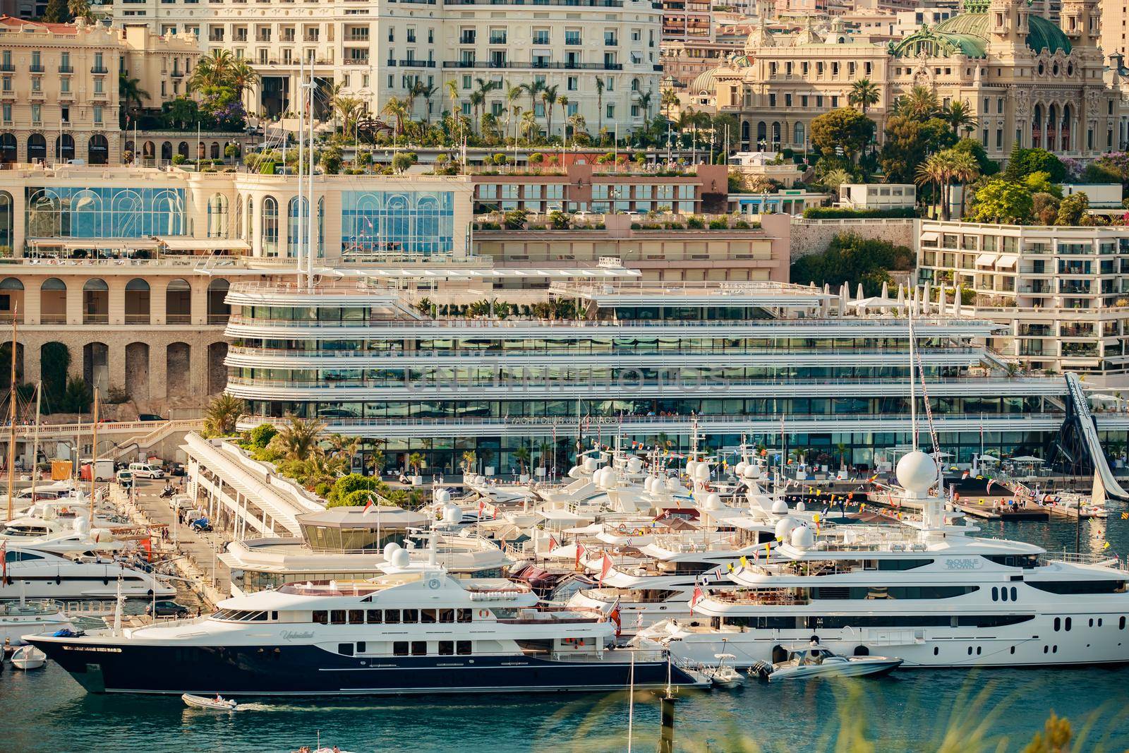 Monaco, Monte Carlo, 21 August 2017: Aerial view of port Hercules at sunset, mega yachts are moored in marina near yacht club of Monaco, view of city life from old town, a lot of mega yachts and boats. High quality photo