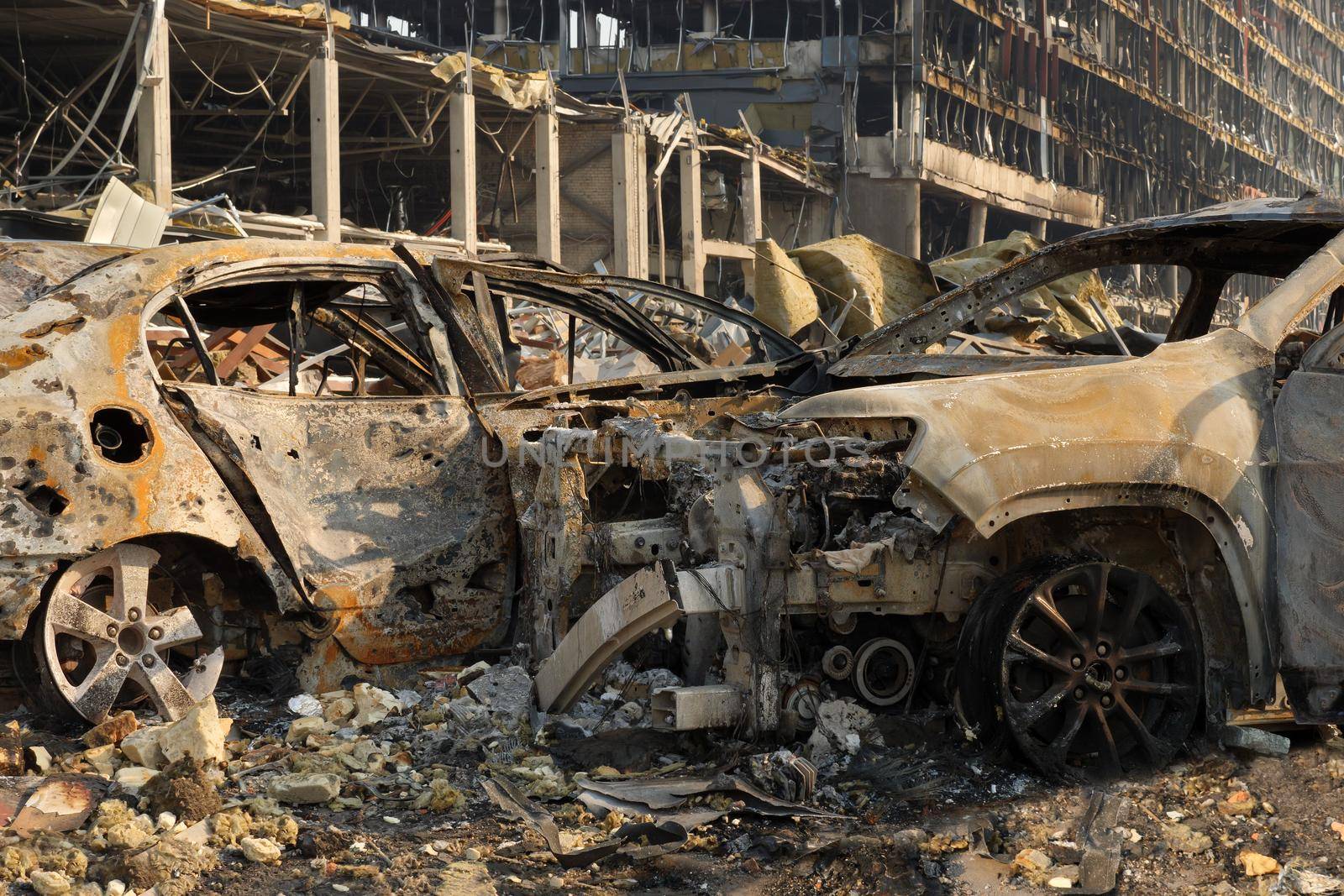 Aftermath shell of civilian bombed city damage car. 2022 Russian invasion of Ukraine war torn city destroyed car burn out. Bomb attack Russia war damage Ukraine city war destruction Russian aggression by synel