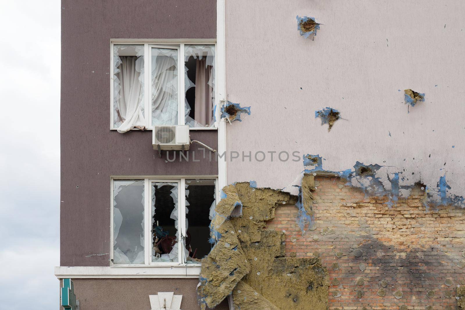 Terror attack Russia war concept. 2022 Russian invasion Ukraine war Bucha destroyed building destruction wall hole shot Irpin aftermath shell of civilian hitting city Bucha damage building destruction by synel