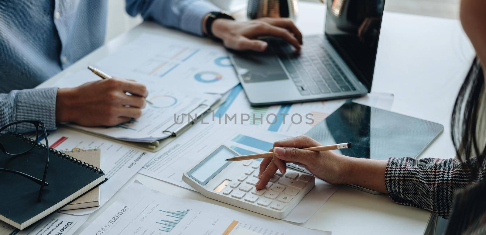 Financial adviser working with client, calculating and analyzing data paperwork chart for meeting team in office room. concept finance and accounting by nateemee
